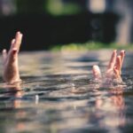 Young asian fat woman drowning in swimming pool,help me please,helping concept.
